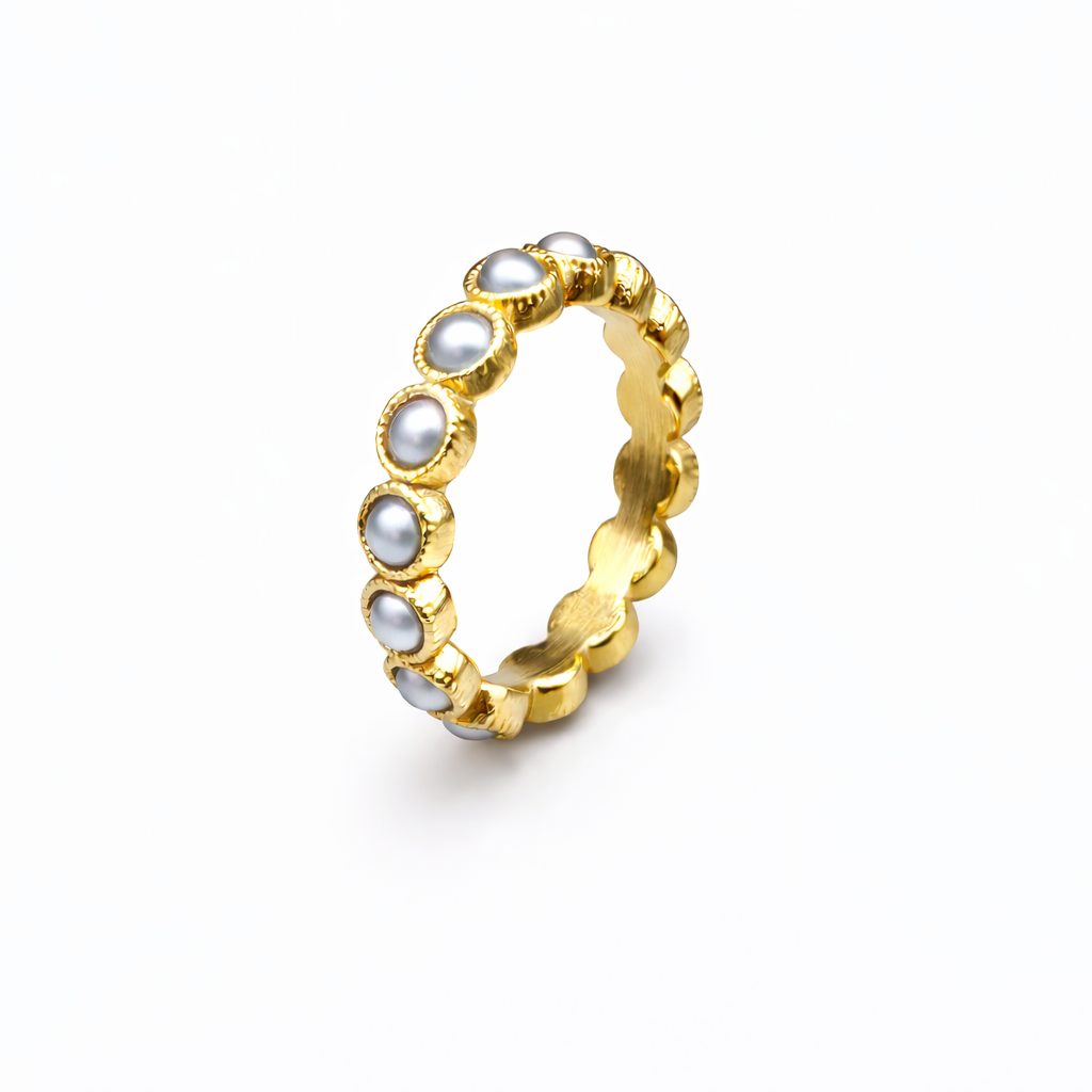 Gold ring with embedded pearls on a white background