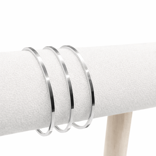 3 silver flat bangles on a stand