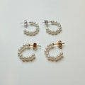 Set of pearl hoop earrings on a light gray background