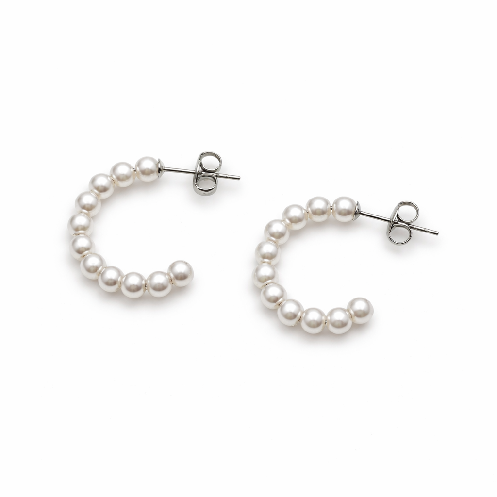 Pair of pearl hoop earrings on a white background