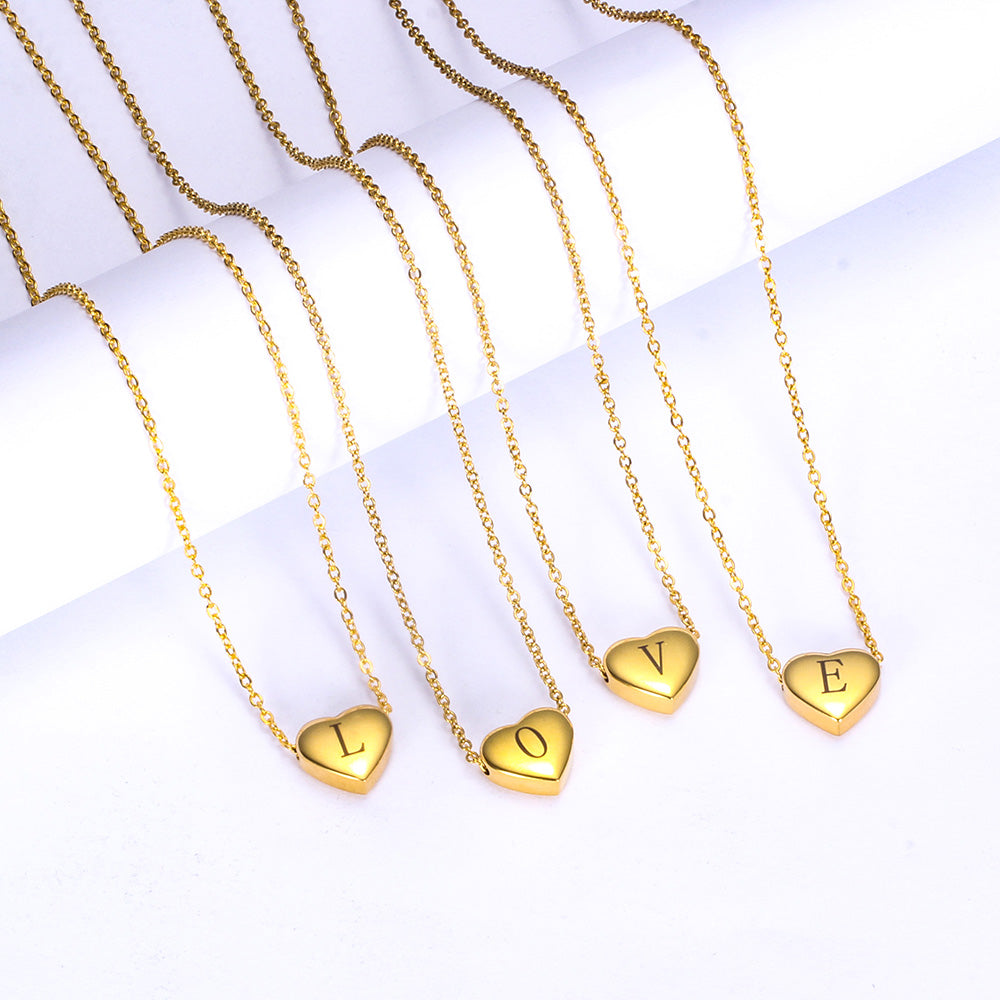 Gold necklaces with heart-shaped pendants spelling 'LOVE' on a white background