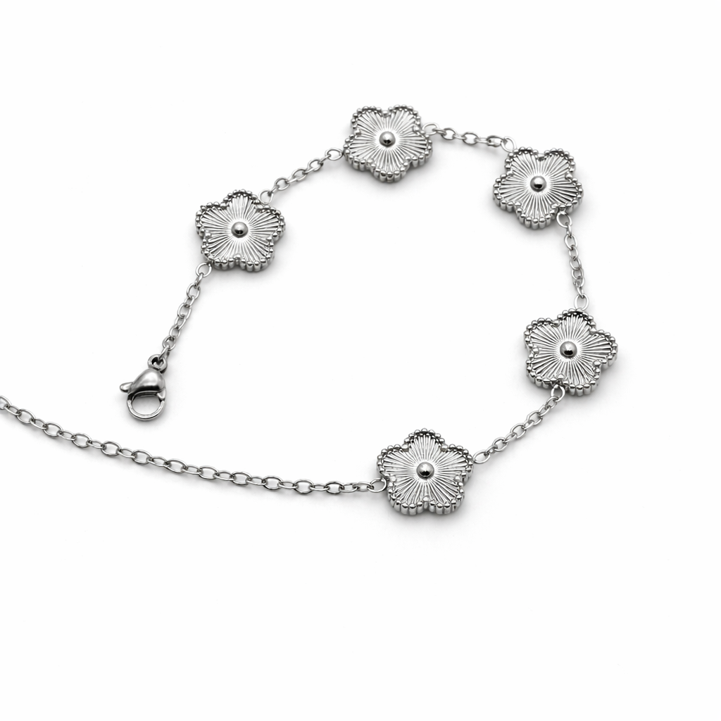 Silver bracelet with floral designs on a white background