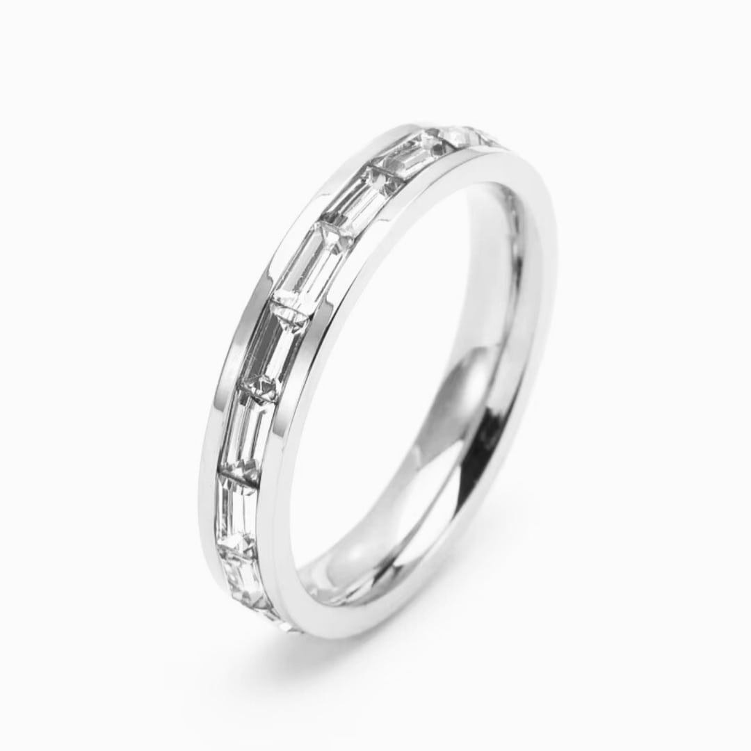 Silver ring with diamond accents on a white background