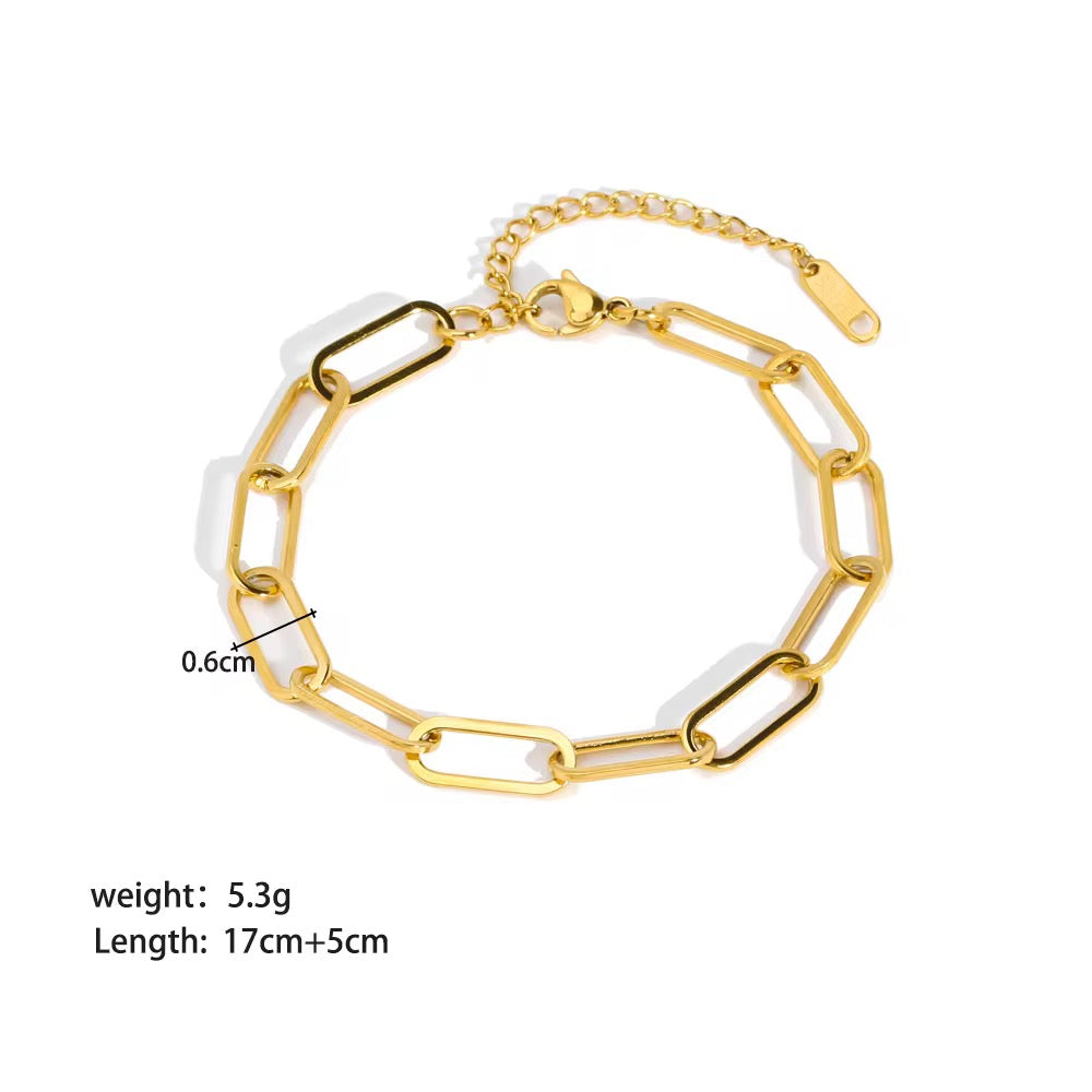 Gold and white chain bracelet with measurements on a white background