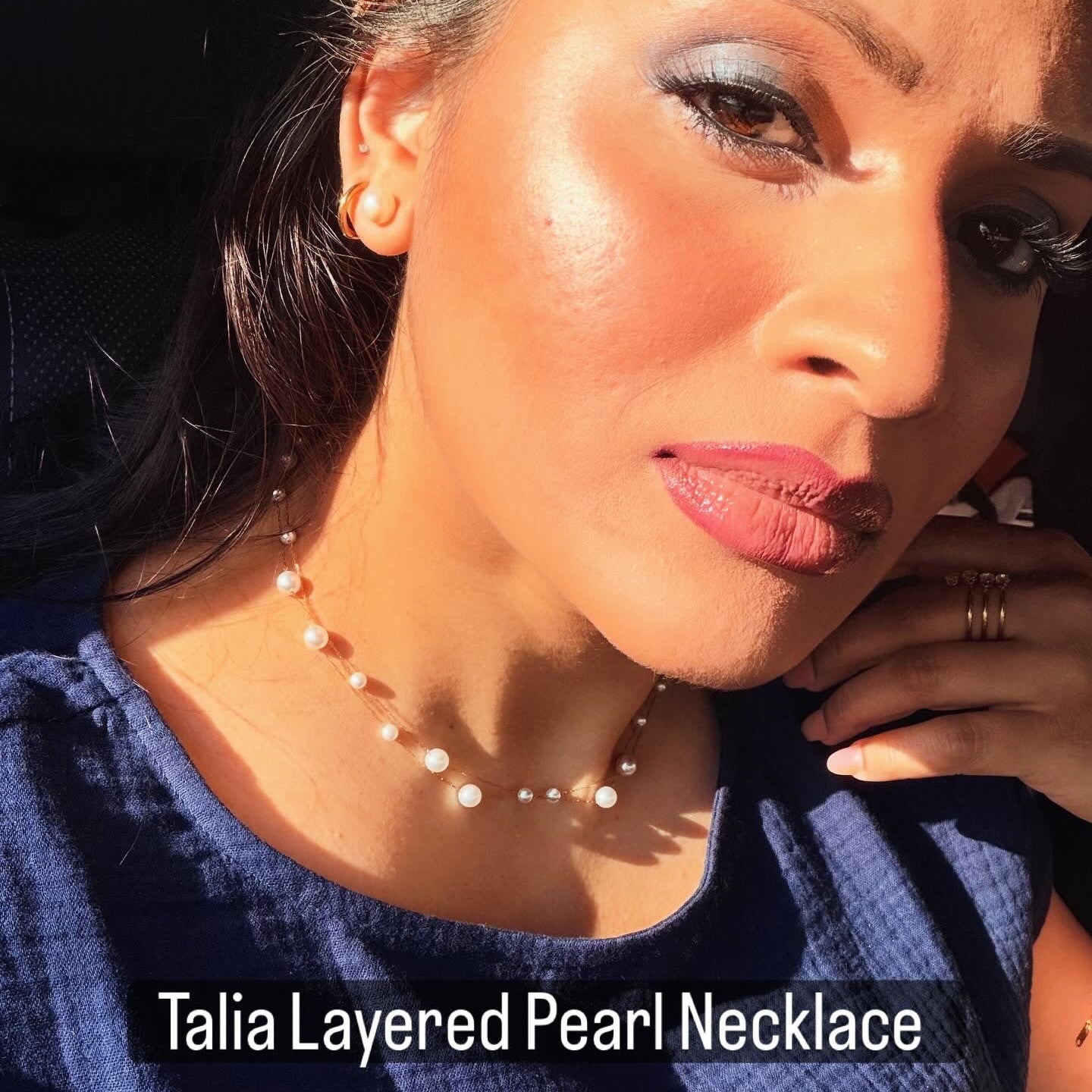 Woman wearing a layered pearl necklace with text overlay