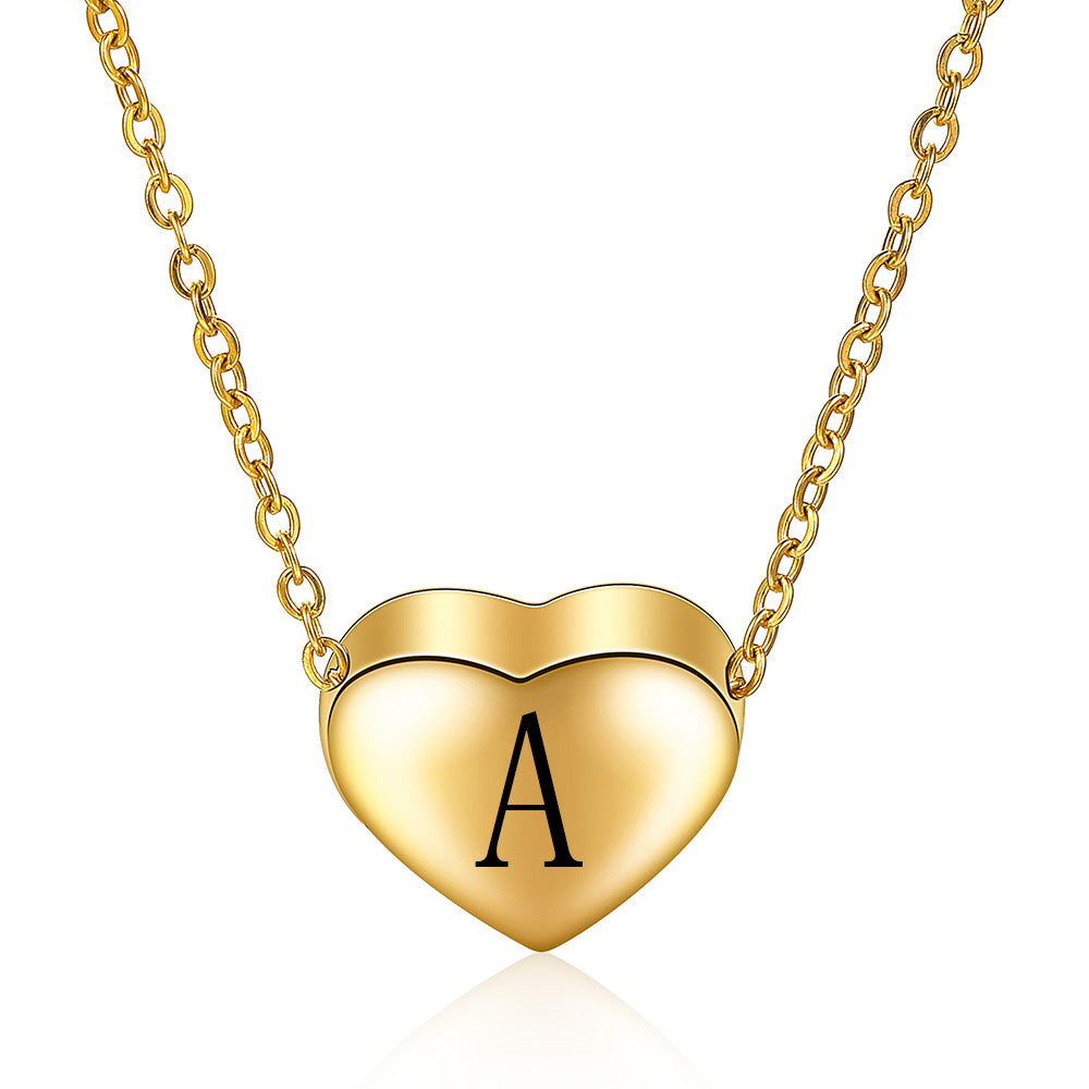 Gold heart-shaped necklace with letter 'A' on a white background