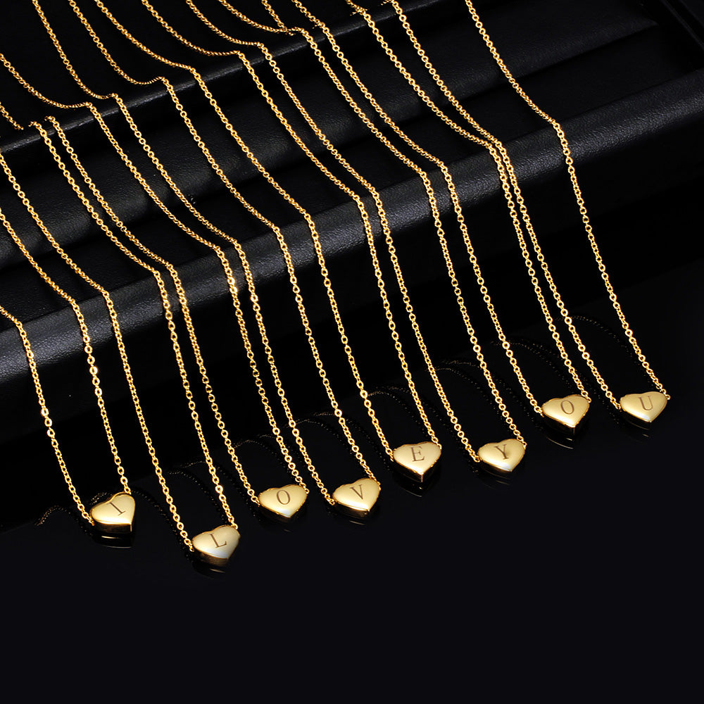Gold necklaces with heart-shaped pendants on a black background
