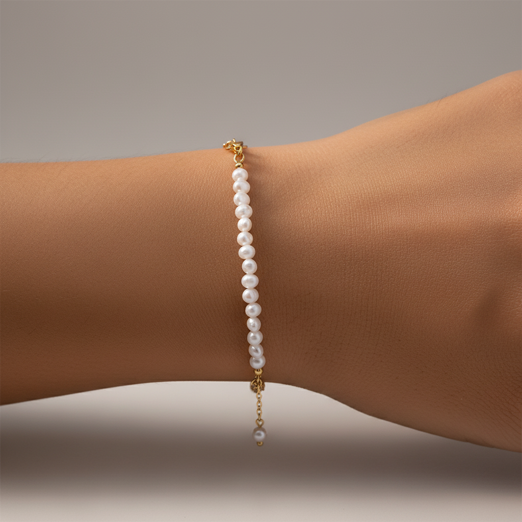 Pearl bracelet on a wrist with a neutral background