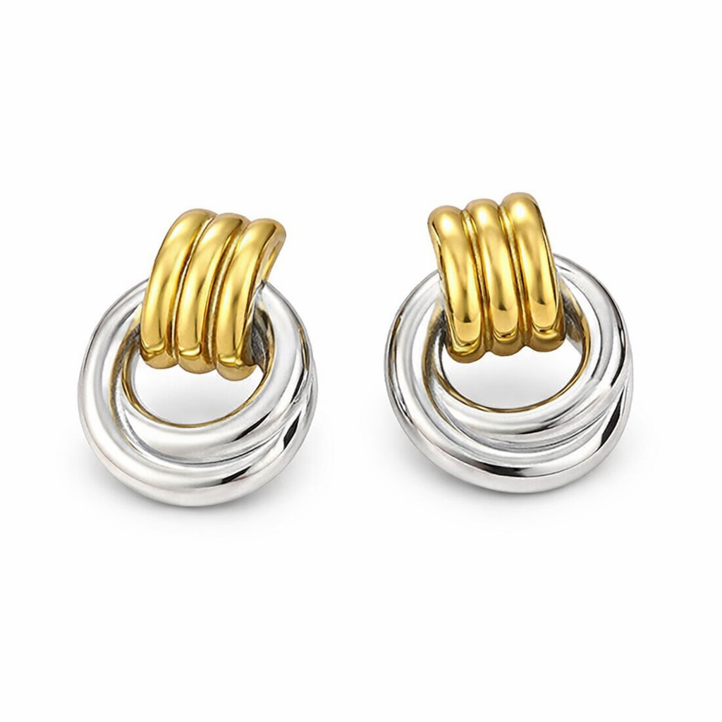 Pair of earrings with gold and silver circular design on a white background